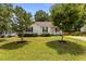 Well-maintained front yard showcasing a manicured lawn, shade trees, and inviting curb appeal at 304 Quailwood Dr, Fuquay Varina, NC 27526