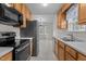 A kitchen with matching appliances, cabinets and a view into a dining area at 304 Quailwood Dr, Fuquay Varina, NC 27526