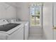 A laundry room with shelving and a window at 304 Quailwood Dr, Fuquay Varina, NC 27526