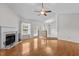 Spacious living room with a fireplace, ample natural light, and a view of the dining area at 304 Quailwood Dr, Fuquay Varina, NC 27526