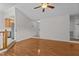 Open-concept living room with hardwood floors, a stairway to the basement, and seamless flow at 304 Quailwood Dr, Fuquay Varina, NC 27526