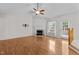 Bright and airy living room featuring vaulted ceilings, a fireplace, and wood-look flooring at 304 Quailwood Dr, Fuquay Varina, NC 27526