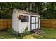This backyard shed has a ramp and is surrounded by garden at 304 Quailwood Dr, Fuquay Varina, NC 27526