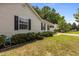Exterior side view showcasing siding, trimmed bushes, mulched flower bed and manicured lawn at 304 Quailwood Dr, Fuquay Varina, NC 27526