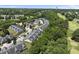 Community aerial view featuring mature trees, manicured lawn, and golf course in the background at 3207 Imperial Oaks Dr, Raleigh, NC 27614