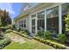 Landscaped backyard with stone pathway, greenery, flowers, fenced in yard and access to the sunroom at 3207 Imperial Oaks Dr, Raleigh, NC 27614