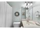 Cozy bathroom featuring neutral tones, white fixtures, and a decorative mirror, creating a serene space at 3207 Imperial Oaks Dr, Raleigh, NC 27614