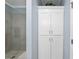 Bathroom with updated tile, white cabinetry, storage and glass shower in the home at 3207 Imperial Oaks Dr, Raleigh, NC 27614