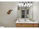 Bathroom featuring a vanity with an oval sink and a large mirror with vanity lights at 3207 Imperial Oaks Dr, Raleigh, NC 27614