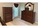 Bedroom with wooden dresser and cabinet with drawers, topped with mirror for getting ready at 3207 Imperial Oaks Dr, Raleigh, NC 27614