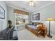 Bright bedroom features a comfortable daybed, a piano, and a large window with a pleasant view at 3207 Imperial Oaks Dr, Raleigh, NC 27614