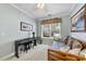 Bright bedroom features a comfortable daybed, a piano, and a large window with a pleasant view at 3207 Imperial Oaks Dr, Raleigh, NC 27614