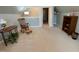 Bonus room with neutral carpet, rocking chair and view of storage closet and stairway at 3207 Imperial Oaks Dr, Raleigh, NC 27614