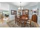 Elegant dining room features a wooden table, vintage china cabinet, and views to the kitchen and living room at 3207 Imperial Oaks Dr, Raleigh, NC 27614