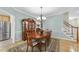 Elegant dining room boasts a wooden table, a vintage china cabinet, and a classic chandelier at 3207 Imperial Oaks Dr, Raleigh, NC 27614