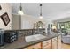 Spacious kitchen features gray countertops, a tiled backsplash, and modern lighting fixtures at 3207 Imperial Oaks Dr, Raleigh, NC 27614