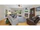 Bright living room with fireplace, hardwood floors, and comfortable seating at 3207 Imperial Oaks Dr, Raleigh, NC 27614