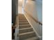 Carpeted staircase with wooden banister leading to the upper level of the house at 3207 Imperial Oaks Dr, Raleigh, NC 27614