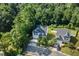 Aerial shot of a lovely two-story home with a lush green yard, mature trees, and a two-car garage at 3401 Grosbeak Way, Raleigh, NC 27616