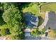 Aerial view of a charming home with a well-manicured lawn, mature trees, and a two-car garage at 3401 Grosbeak Way, Raleigh, NC 27616