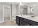 Bathroom featuring double sinks, a large mirror, and access to the walk-in closet and walk-in shower for convenience at 3401 Grosbeak Way, Raleigh, NC 27616