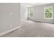 Spacious bedroom with carpet and two large windows at 3401 Grosbeak Way, Raleigh, NC 27616
