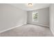 Spacious, carpeted bedroom features neutral colors and natural light from the window at 3401 Grosbeak Way, Raleigh, NC 27616