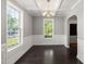Elegant dining room with coffered ceiling, wainscoting detail, and large windows providing natural light at 3401 Grosbeak Way, Raleigh, NC 27616