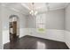 Formal dining room with coffered ceiling, wainscoting, hardwood floors, and ample natural light at 3401 Grosbeak Way, Raleigh, NC 27616