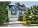 Lovely two-story home featuring blue accents, a well-kept lawn, and an attached two-car garage at 3401 Grosbeak Way, Raleigh, NC 27616