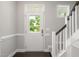 Bright foyer with a white door, staircase, and neutral walls, creating an inviting entrance at 3401 Grosbeak Way, Raleigh, NC 27616