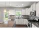 Well-lit kitchen with stainless steel appliances, gray backsplash, and granite countertops at 3401 Grosbeak Way, Raleigh, NC 27616