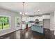 Spacious kitchen features white cabinets, a center island, and stainless steel appliances at 3401 Grosbeak Way, Raleigh, NC 27616