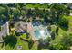 Aerial view of a community pool, with lounge chairs and umbrellas, surrounded by lush greenery and landscaping at 3401 Grosbeak Way, Raleigh, NC 27616