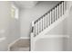 A carpeted staircase with white railing at 3401 Grosbeak Way, Raleigh, NC 27616
