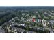 Aerial view of a neighborhood showing rooftops, trees, and a lake with target house at 3423 Van Hessen Dr, Raleigh, NC 27614