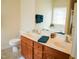 Bathroom vanity with double sinks and a large mirror and a toilet with beige wall paint at 3423 Van Hessen Dr, Raleigh, NC 27614