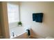 Soaking bathtub with tile flooring and a window above with plants at 3423 Van Hessen Dr, Raleigh, NC 27614