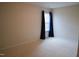 Bright bedroom with a window dressed with blue curtains and neutral carpeting at 3423 Van Hessen Dr, Raleigh, NC 27614
