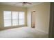 Spacious bedroom with carpeted floors, neutral walls, ceiling fan and large windows at 3423 Van Hessen Dr, Raleigh, NC 27614