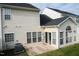 Back exterior featuring a sunroom addition with multiple windows and a patio area at 3423 Van Hessen Dr, Raleigh, NC 27614