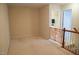Hallway with beige carpet, neutral walls, and a wooden safety gate at 3423 Van Hessen Dr, Raleigh, NC 27614