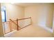 Hallway with beige carpet, neutral walls, and a wooden safety gate at 3423 Van Hessen Dr, Raleigh, NC 27614