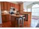 Charming kitchen features wooden cabinets, an island, and stainless steel appliances at 3423 Van Hessen Dr, Raleigh, NC 27614