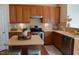 Well-lit kitchen showcases wooden cabinets, a center island, and modern appliances at 3423 Van Hessen Dr, Raleigh, NC 27614