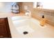 Close up of kitchen sink with countertop, tiled backsplash and window at 3423 Van Hessen Dr, Raleigh, NC 27614
