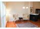 Well-lit living room featuring comfortable armchairs, a fireplace, and hardwood floors at 3423 Van Hessen Dr, Raleigh, NC 27614