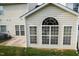 Sunroom addition showing many windows, siding, and concrete patio area at 3423 Van Hessen Dr, Raleigh, NC 27614