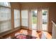 Bright sunroom featuring large windows, sliding glass doors, and wood floors at 3423 Van Hessen Dr, Raleigh, NC 27614