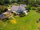 Aerial view of a home featuring an expansive lawn, a screened porch, a deck, and pergola at 3619 Nc-57, Hillsborough, NC 27278